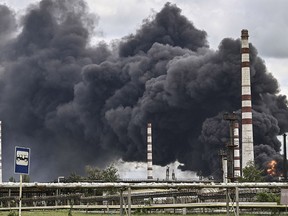 Smoke rises from an oil refinery after an attack outside the city of Lysychansk in the eastern Ukranian region of Donbas, on May 22, 2022, on the 88th day of the Russian invasion of Ukraine.