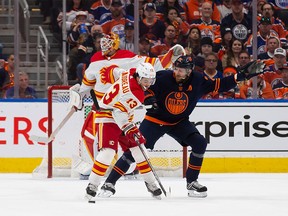 Johnny Gaudreau #13 of the Calgary Flames draws a penalty against Leon Draisaitl #29 of the Edmonton Oilers during the first period in Game 3 of the second round of the 2022 Stanley Cup Playoffs at Rogers Place on May 22, 2022 in Edmonton, Canada.