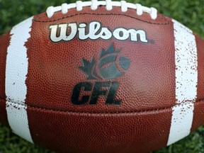 CFL logo on an official Canadian CFL league ball during warm-ups before the Saskatchewan Roughriders CFL game against the Toronto Argonauts on July 11, 2013 at Rogers Centre in Toronto.