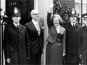 On this day in history in 1979, Conservative Party leader Margaret Thatcher was chosen to become Britain's first female prime minister as the Tories ousted the incumbent Labour government in parliamentary elections. This picture dated May 4, 1979 shows Thatcher waving as she arrives to take office at No. 10 Downing Street in London with her husband Denis (2nd L). Thatcher, the "Iron Lady" who shaped a generation of British politics, died following a stroke on April 8, 2013 at the age of 87. AFP PHOTO/FILES-/AFP/Getty Images
