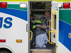 EMS paramedics help a resident after a house fire in Dalhousie on Sunday, May 1, 2022. Three people were taken to hospital.