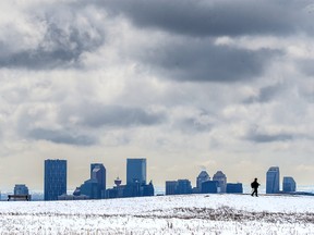 A walker makes their way in the snow on Nose Hill after an overnight storm blanketed parts of Calgary, including almost 10 centimetres on top of Nose Hill on Monday, May 9, 2022.