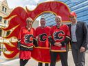Calgary Mayor Jyoti Gondek and Councilmembers from left to right;  Dan McLean, Peter Demong and Evan Spencer stand with the C Calgary Flames logo on fire in front of City Hall on Monday, May 16, 2022. With the Battle of Alberta Stanley Cup playoff series coming up against the Edmonton Oilers, the Mayors and councils have made a playoff bet on the outcome.