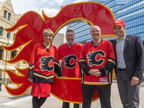 Calgary Mayor Jyoti Gondek and councillors from left; Dan McLean, Peter Demong and Evan Spencer stand with the flaming C Calgary Flames logo in front of City Hall on Monday, May 16, 2022. With the upcoming Battle of Alberta Stanley Cup playoff series against the Edmonton Oilers the mayors and councils have made a playoff wager on the outcome.