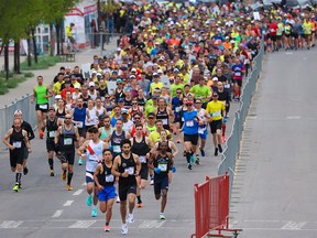 Runners race off the start in the Servus Calgary Marathon and Centaur Subaru Half Marathon at Stampede Park on Sunday, May 29, 2022.