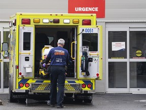 FILE PHOTO: A paramedic loads his stretcher back into the ambulance after bringing a patient to the emergency room at a hospital in Montreal, Thursday, April 14, 2022.