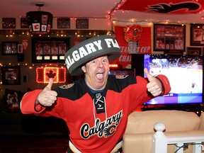 Flames super fan Dean McCord poses for a photo in his living room. McCord has been collecting Flames memorabilia, jerseys and other collectables since he was a child. McCord says his living room is the next best place to watch the game aside from the Dome. May 4, 2022.