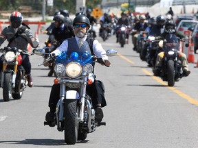 Over one hundred motorcyclists participate in the 11th Distinguished Gentleman's Ride along 9th Ave SE. Dressed and groomed, the runners hit the downtown streets to raise more than $23,000 for Movember, a global charity that supports men battling prostate cancer. Sunday May 22, 2022.