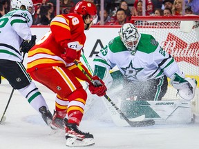 Dallas Stars goaltender Jake Oettinger (29) makes a save against Calgary Flames left wing Andrew Mangiapane (88) during the third period in Game 5 of the first round of the 2022 Stanley Cup Playoffs at Scotiabank Saddledome on May 11, 2022.