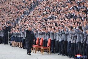 Kim Jong Un waves toward students and young workers, who are all unmasked, during a photo session in Pyongyang, North Korea, in this undated photo released by North Korea’s Korean Central News Agency on May 1, 2022.