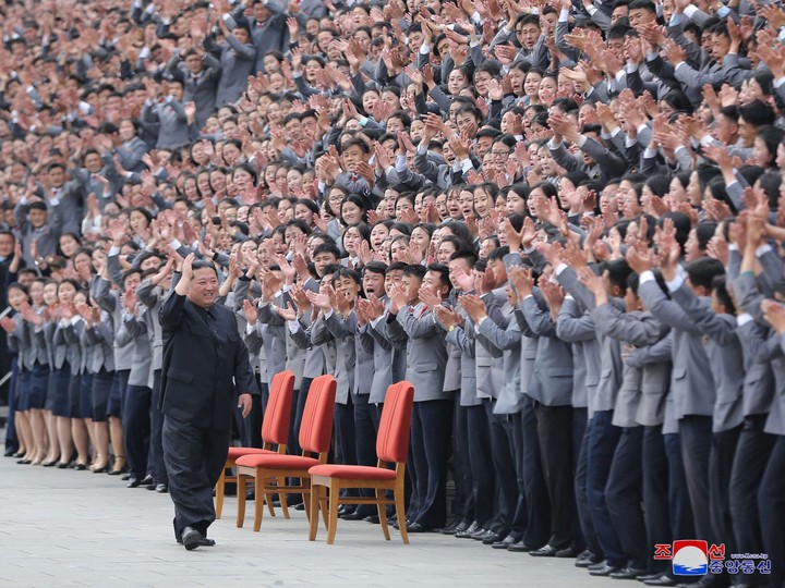  Kim Jong Un waves toward students and young workers, who are all unmasked, during a photo session in Pyongyang, North Korea, in this undated photo released by North Korea’s Korean Central News Agency on May 1, 2022.