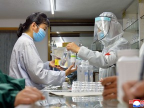 Army medics involved in medicine supply distribution work at a pharmacy amid concerns of coronavirus disease (COVID-19) spread in Pyongyang, North Korea May 22, 2022 in this photo released May 23, 2022 by the country’s Korean Central News Agency.