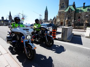 Police patrol Wellington Street in Ottawa prior to the arrival of the “Rolling Thunder” convoy protest on Friday, April 29, 2022.