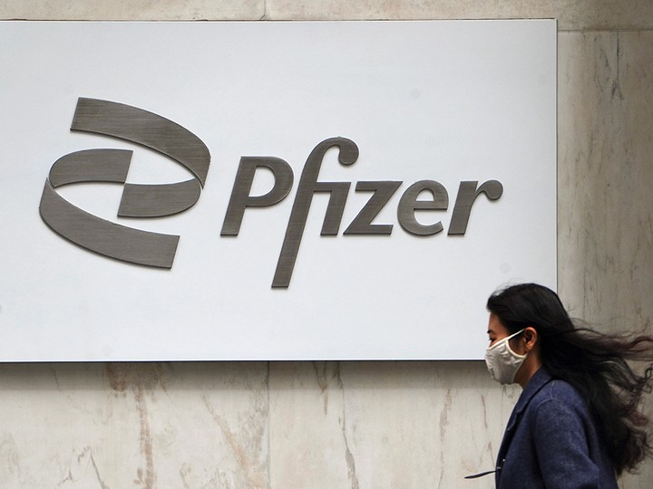  A woman walks past a Pfizer logo in the Manhattan borough of New York City on April 1, 2021.