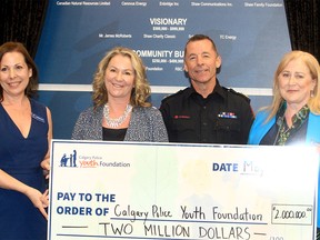 From left, Barbara Pohl, Senior Director Community Engagement with Calgary Police Foundation, Julie Shaw, President Shaw Family Foundation, Calgary Police Chief Mark Neufeld and Susan Cron, Executive Director of Calgary Youth Foundation, pose for a photo with a $2-million donation cheque. The Shaw Family Foundation made the donation to support the Calgary Police Youth Foundation.  May 3, 2022.