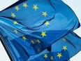 A picture taken on May 11, 2022 shows flags of the European Union outside the European commission headquarters in Brussels.