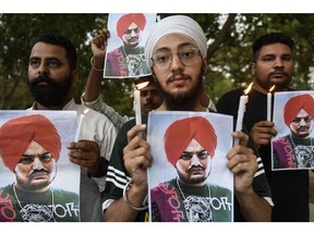 Youth pay tribute to late Punjabi singer Sidhu Moose Wala who was shot dead a day earlier in Mansa district in India's Punjab state, during a candlelight vigil in Amritsar on May 30, 2022.