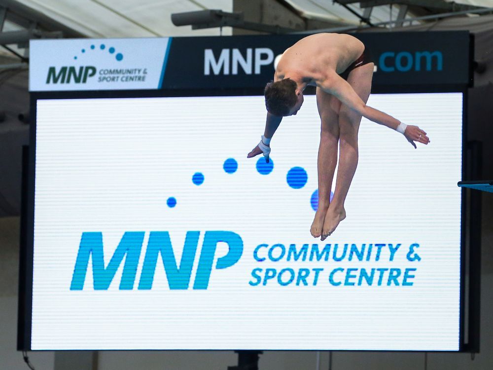 Dive Calgary diver Theo Hrach dives in front of a sign following the announcement that MNP will be the new naming sponsor for the Lindsay Park sports centre on Wednesday, May 18, 2022. MNP is one of Canada's largest accounting firms and has its headquarters in Calgary. It will be sponsoring the centre for 10 years.
