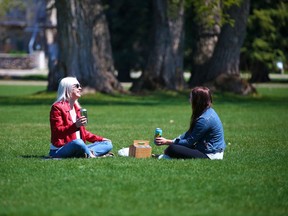 Gillian Meades, left, and Charlotte Van Horne enjoy the day in Riley Park on Monday, May 10, 2021. Calgary announced it is bringing back its alcohol in parks program for 2022 at select parks across the city.