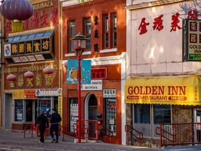 Colourful store fronts in Calgary's Chinatown are lit by reflected morning light on Wednesday, November 24, 2021.