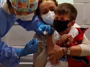 Antonio, 6, receives his first dose of the COVID-19 vaccine at the Explora Children’s Museum, in Rome, Dec. 16, 2021.