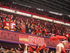 Fans celebrate an Elias Lindholm goal during the first period of the Flames' playoff game at the Scotiabank Saddledome on Tuesday.