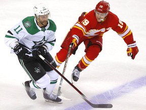 Calgary Flames Matthew Tkachuk battles Dallas Stars Luke Glendening in first period during round one of the Western Conference NHL playoff action at the Scotiabank Saddledome in Calgary on Tuesday, May 3, 2022.