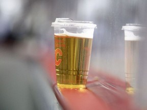 A beer on the ledge of the boards in the front row during the third period of action as the Calgary Flames beat the visiting Arizona Coyotes 9-1 at the Saddledome. April 16, 2022.