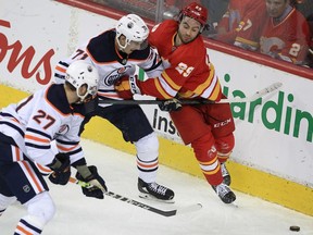 Dillon Dube of the Calgary Flames fights for a puck against centre Ryan McLeod of the Edmonton Oilers during the third period of action as the Calgary Flames lost to the visiting the Edmonton Oilers 5-3 in Game 2 of the second round of the Stanley Cup Playoffs at the Saddledome. Friday, May 20, 2022. Brendan Miller/Postmedia