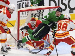 Dallas Stars centre Roope Hintz is tripped in front of Calgary Flames goaltender Jacob Markstrom during Game 6 of their first-round playoff series at American Airlines Center in Dallas on Friday, May 13, 2022.