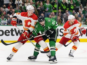 Calgary Flames defenseman Nikita Zadorov and forward Trevor Lewis defend against Dallas Stars forward Tyler Seguin in Game 6 of their first-round series at the Airlines Center in Dallas on Friday, May 13, 2022.