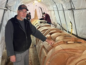 Haida carver Christian White works on his new totem pole project in Old Masset, BC Courtesy of Andrew Penner