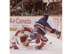 The last playoff series between the Oilers and the Flames: In this April 12, 1991 photo, the Edmonton Oilers' Glenn Anderson flies through the air after a collision with the Flames' #3 Frank Musil. Calgary Herald archives.
