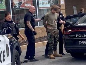 A man is detained following a mass shooting in the parking lot of TOPS supermarket, in a still image from a social media video in Buffalo, New York, U.S. May 14, 2022.