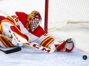 Calgary Flames goaltender Jacob Markstrom (25) dives for a puck during first period NHL second round playoff hockey action against the Edmonton Oilers on Sunday, May 22, 2022 in Edmonton.