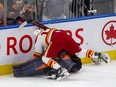 Edmonton Oilers goaltender Mike Smith is pushed over by Calgary Flames forward Milan Lucic during Game 3 of their second-round playoff series at Rogers Place in Edmonton on Sunday, May 22, 2022.