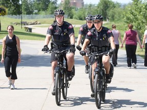 Calgary Police Service officers patrol along the bike path at Prince's Island. Calgary would be much the poorer without the efforts our police, writes Jackson McDonough, co-founder of Beacons of Hope.