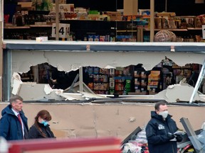 Shattered windows and the damaged facade of the King Soopers grocery store in Boulder, Colorado where a mass shooting took place on March 22, 2021.