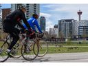 Now is the time to chart a new, sustainable course for greater downtown Calgary, reinventing the core of being a place that delivers a high quality of life for all citizens at a much lower rate of consumption, say the authors .  Pictured, cyclists on the Riverwalk path in the East Village earlier this year.  Azin Ghaffari/Postmedia