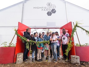 Cutting the flower wreath ribbon at Highfield Farm's new greenhouse.