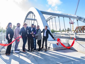 From Left; Kerensa Swanson-Fromherz, director of transportation infrastructure with the City of Calgary, Councillor Courtney Walcott, Councillor Gian-Carlo Carra, Alberta minister of transportation Prasad Panda, Elder Rodin Big Snake, Councillor Terry Wong and Calgary-Buffalo MLA Joe Ceci cut the ribbon at the official opening of 9th Ave. bridge on Tuesday, June 28, 2022.