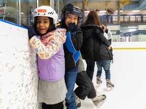Afghan children, new to Canada, try out skating during a tour of Village Square Leisure Centre on March 15, 2022.