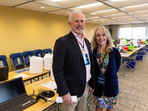 FILE PHOTO: United Conservative Party leadership review returning officer Rick Orman (left) and UCP president Cynthia Moore pose for a photo in the leadership review validation centre at Manulife Place in Edmonton, on Wednesday, May 11, 2022.