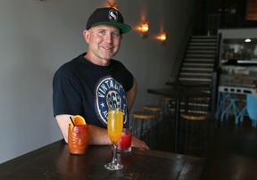 Mike Stanfield with three of Starr DIstilling’s featured cocktails: a Tikki Island (peach vodka), Hamble (gin and raspberry vodka and summer fruits) and a peach sparkler (Prosecco, peach vodka and peach pearls). Jim Wells/Postmedia