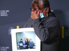 Anne Crowshoe, Colton Crowshoe’s aunt, holds a family photo and becomes emotional during a press conference at Calgary Police HQ in Calgary on Thursday, June 23, 2022. Authorities and family continue to look for answers in Colton Crowshoe’s murder and believe there are people in the community who have yet to come forward.