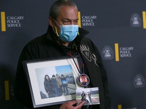Jimmy Crowshoe, Colton Crowshoe's father, holds a family photo during a press conference at Calgary Police HQ in Calgary on Thursday, June 23, 2022. Authorities and family continue to look for answers in Colton Crowshoe's murder and believe there are people in the community who have yet to come forward.
