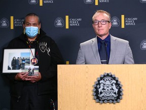 Jimmy Crowshoe, Colton Crowshoe's father, holds a family photo as Calgary Police Staff Sergeant Sean Gregson Homicide Unit speaks during a press conference at Calgary Police HQ in Calgary on Thursday, June 23, 2022.