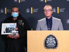 Jimmy Crowshoe, Colton Crowshoe’s father, holds a family photo as Calgary Police Staff Sergeant Sean Gregson Homicide Unit speaks during a press conference at Calgary Police HQ in Calgary on Thursday, June 23, 2022. Authorities and family continue to look for answers in Colton Crowshoe’s murder and believe there are people in the community who have yet to come forward.