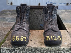 A pair of miner's boots inscribed with the date of June 6, 1882, and today's date are left at the entrance gate of Kellingley Colliery in Yorkshire, northern England on December 18, 2015 on the mine's last operational day. The shutdown of the mine in Yorkshire in northern England closes a 200-year chapter of Britain's industrial history.