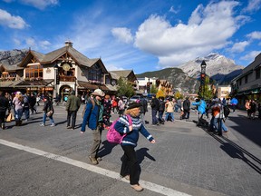 Visitors stroll the busy streets of downtown Banff.